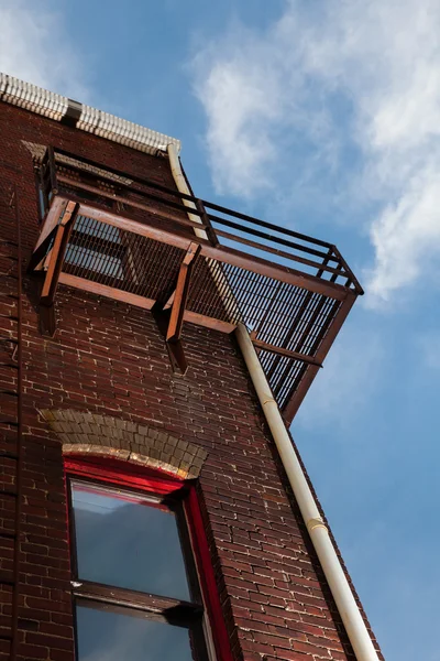 Fire escape on brick building from below — Stock Photo, Image