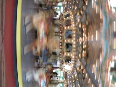 Fast moving carousel at Glen Echo park clipart