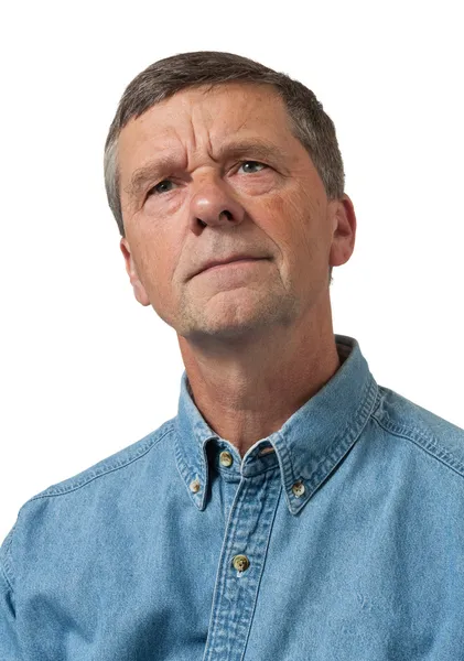Senior man in blue shirt looks pensive — Stock Photo, Image