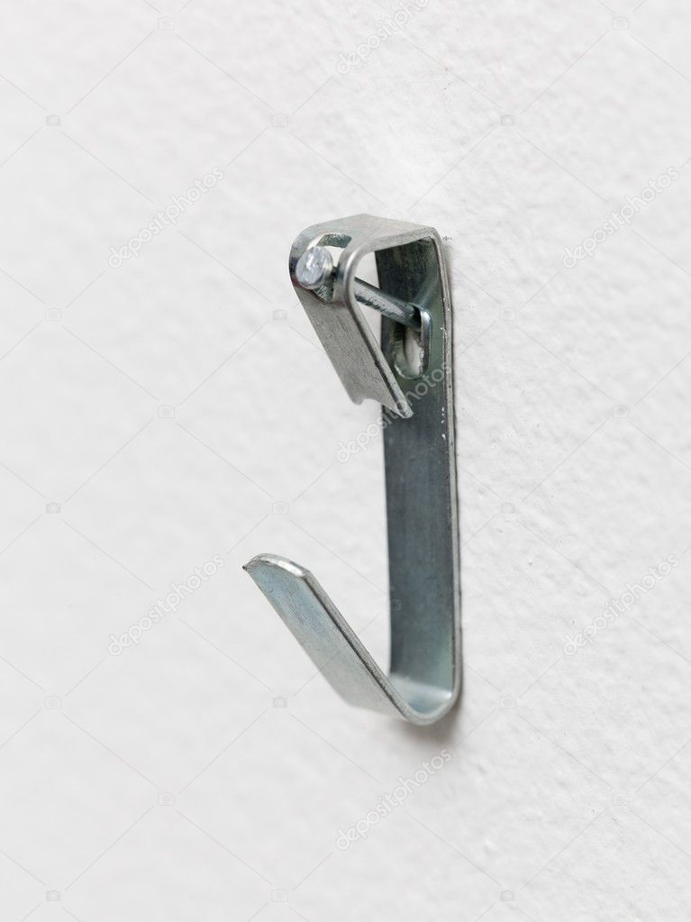 Macro of steel picture hook nailed to wall