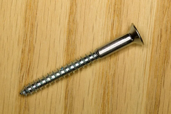 Macro image of steel screw on piece of wood — Stock Photo, Image