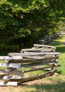 Split rail fence by edge of forest clipart