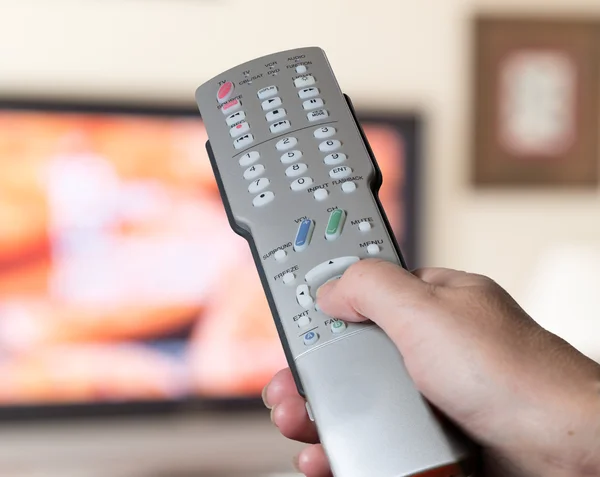 Close up of TV remote control with television — Stock Photo, Image
