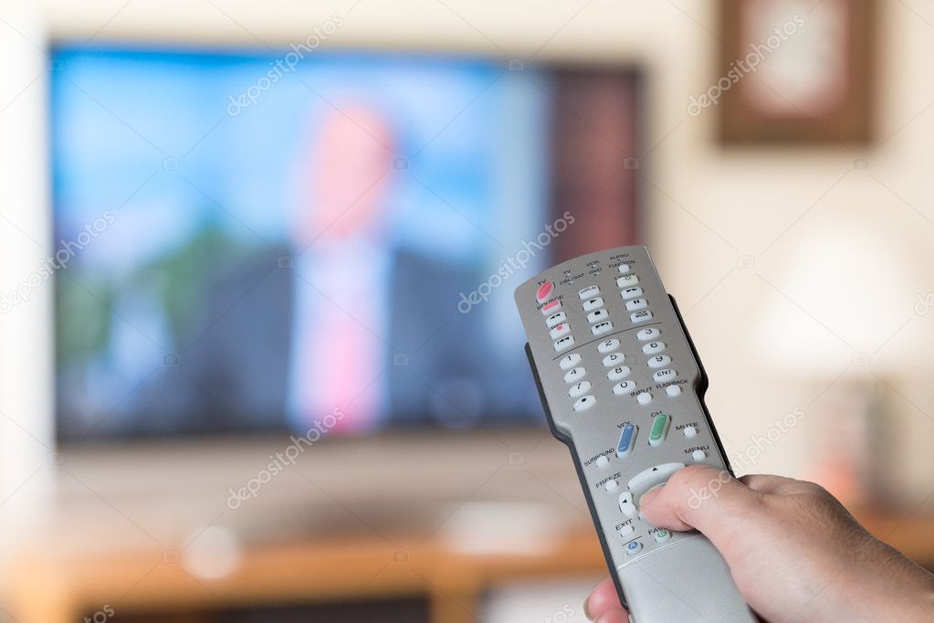 Close up of TV remote control with television