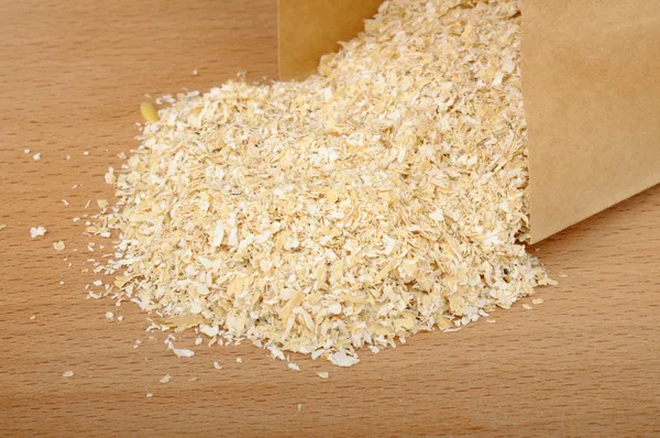 Oat bran in a paper bag — Stock Photo, Image