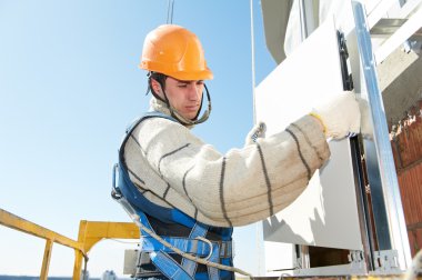 Builder at aerated facade tile installation clipart