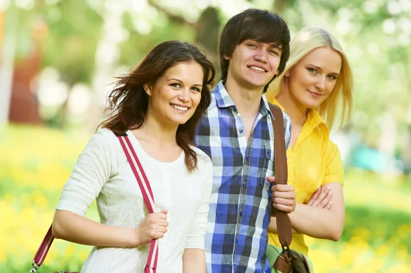 Three young students group outdoors — Stock Photo, Image