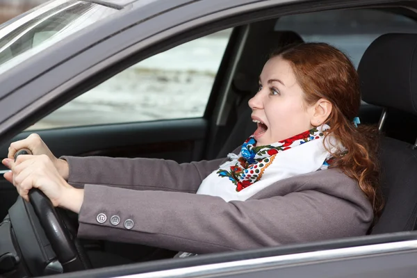 Pretty young Caucasian woman stopping the car and screaming Looking forward — Stock Photo, Image