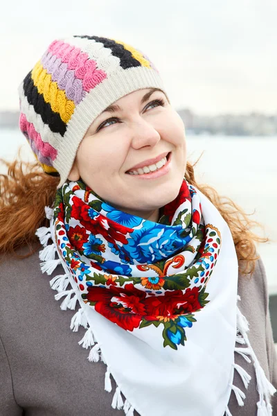 Close up portrait of happy young Caucasian female with scarf on neck. Standing outdoor — Stock Photo, Image