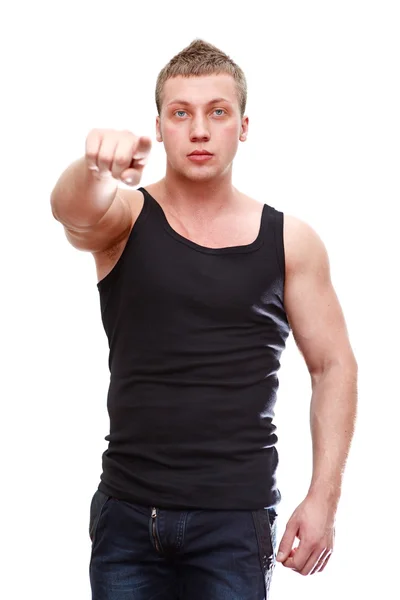 Um belo homem musculoso caucasiano apontando em camiseta preta isolada em fundo branco . — Fotografia de Stock
