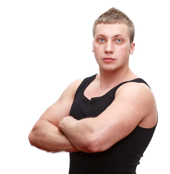 Um homem musculoso caucasiano bonito em t-shirt preta com as mãos apertadas — Fotografia de Stock