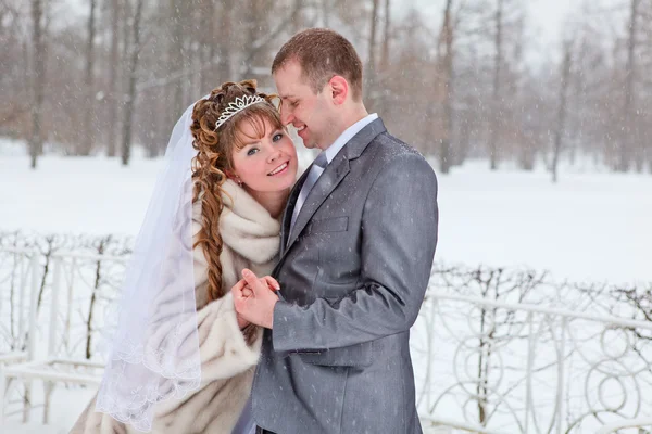 Young wedding Caucasian Russian couple walking on snowy park. Winter season in Russia — Stock Photo, Image