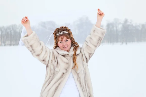 Vackra kaukasiska ryska bruden i vit klänning och päls dansa på snöiga fältet i vintersäsongen, Ryssland — Stockfoto