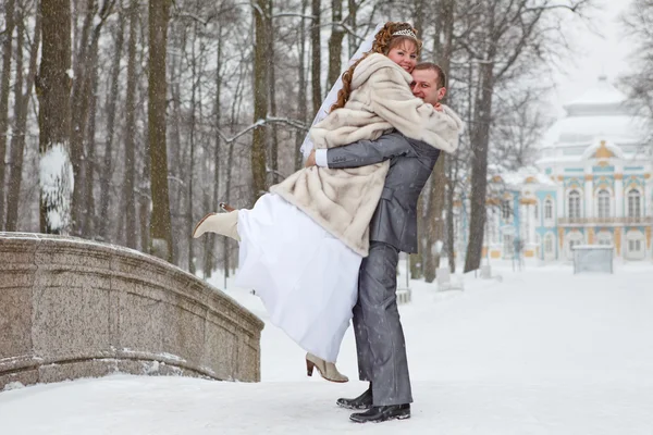 Young wedding Caucasian Russian couple embracing on snowy park. Winter season in Russia — Stock Photo, Image