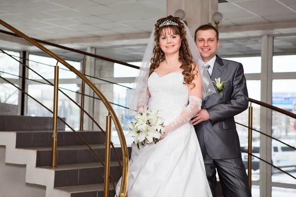 Young wedding Caucasian Russian couple standing on stairs — Stock Photo, Image