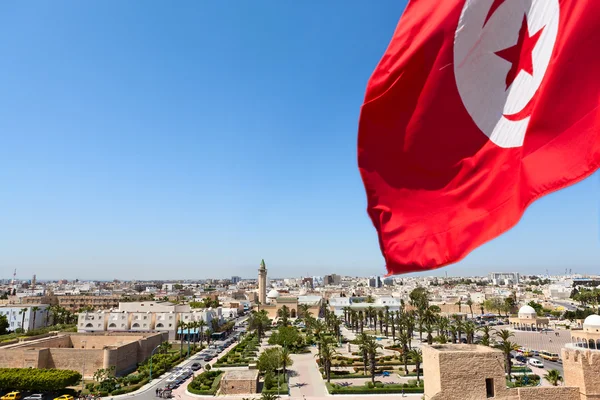 National flag of Tunisia against the city — Stock Photo, Image