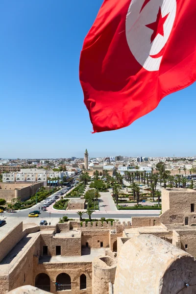 stock image National flag of Tunisia against the city