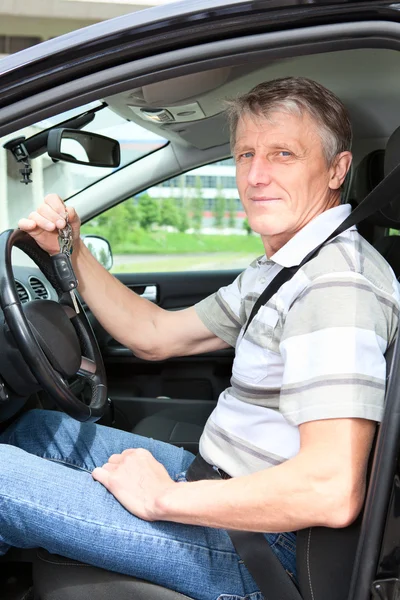 Happy mature driver with car key in car — Stock Photo, Image