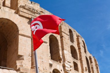 National flag of Tunisia on Tunisian Amphitheatre background in El Djem, Mahdia clipart