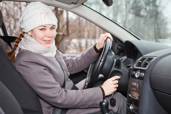 Female driver putting ignition key — Stock Photo, Image
