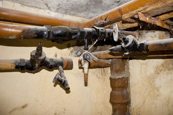 Old pipes in a basement — Stock Photo, Image