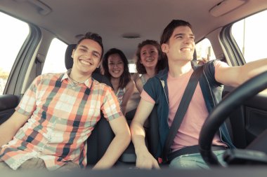 Four Friends in a Car Leaving For Vacation clipart