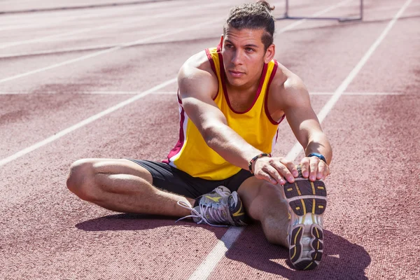 Track and Field Athlete Stretching — Stock Photo, Image