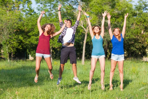 Groupe d'adolescents sautant au parc — Photo