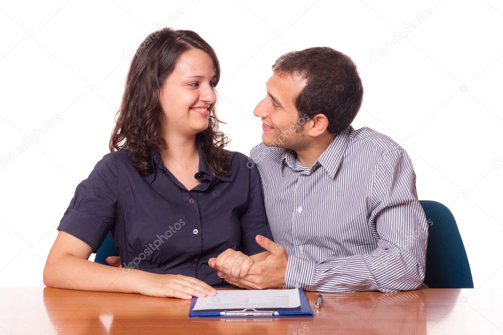 Happy Young Couple with Important Document to Sign