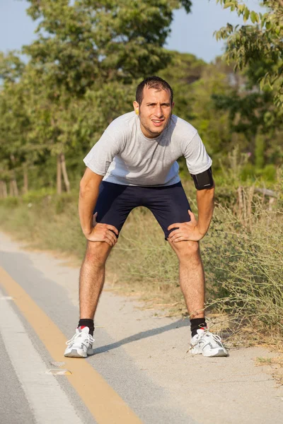 Trött ung man efter jogging — Stockfoto