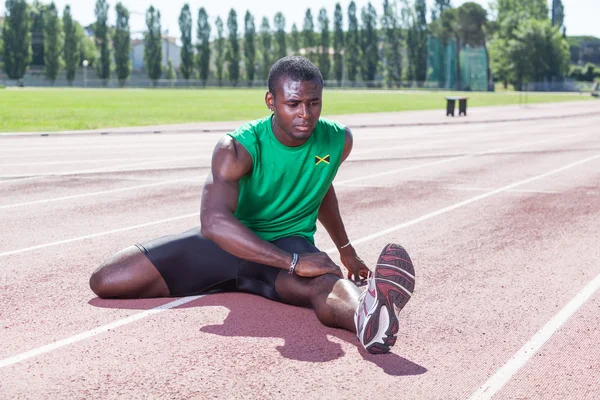 Track and Field Athlete Stretching — Stock Photo, Image