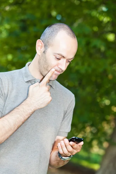 Man with Mobile Phone at Park — Stock Photo, Image