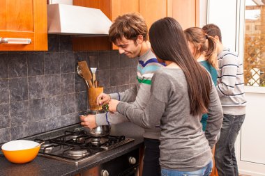 Happy Multiracial Couple in the Kitchen clipart