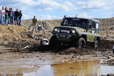 Off-road car in difficult terrain clipart