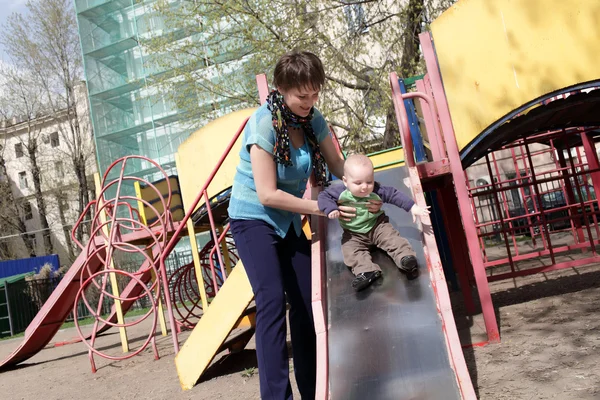Mother with child on slide — Stock Photo, Image