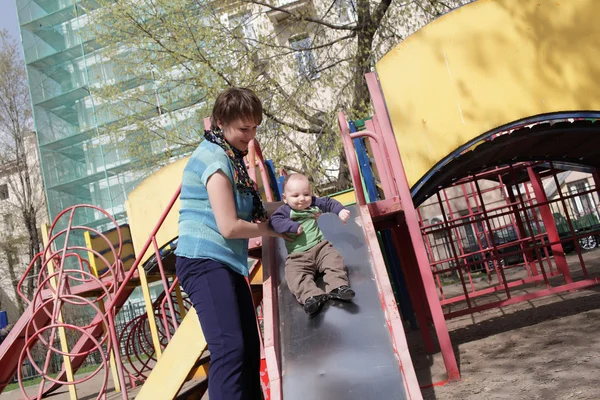 Mother with toddler on slide — Stock Photo, Image