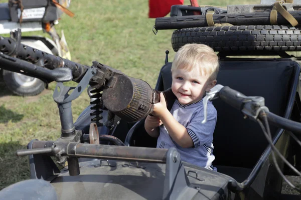 Stock image Child in sidecar with gun