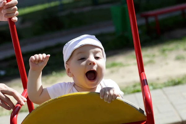 Happy baby on swing — Stok Foto