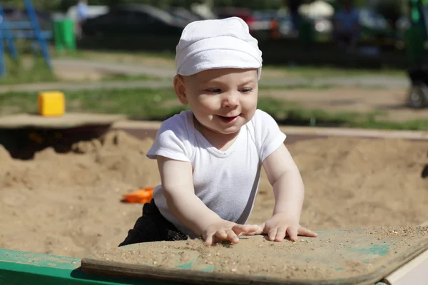 Happy baby playing in sandbox — Stok Foto