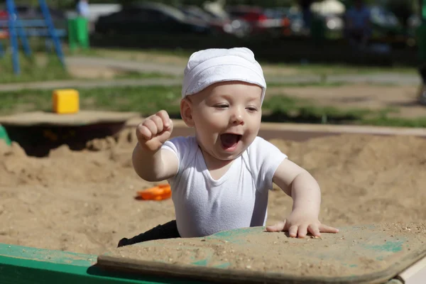 Happy toddler in sandbox — Stock Photo, Image