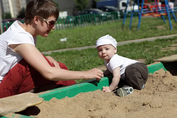 Mother and baby in sandbox — Stock Photo, Image