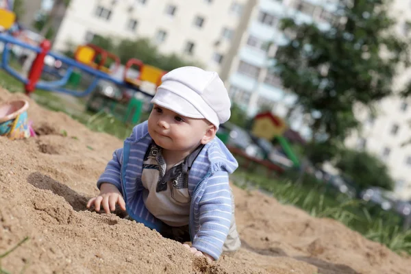 Baby crawling in sandbox — Stock Photo, Image