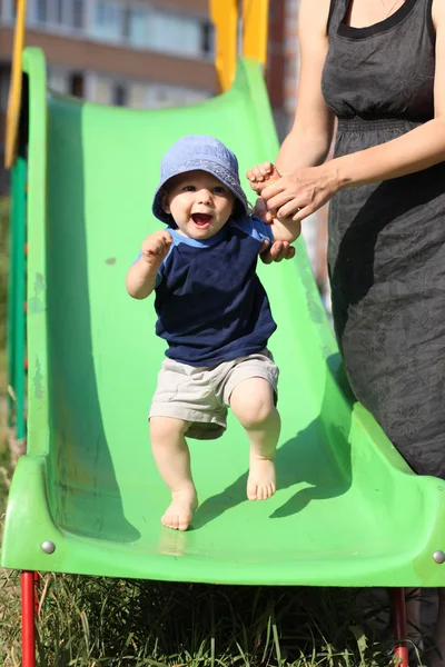 Excited child on slide — Stock Photo, Image