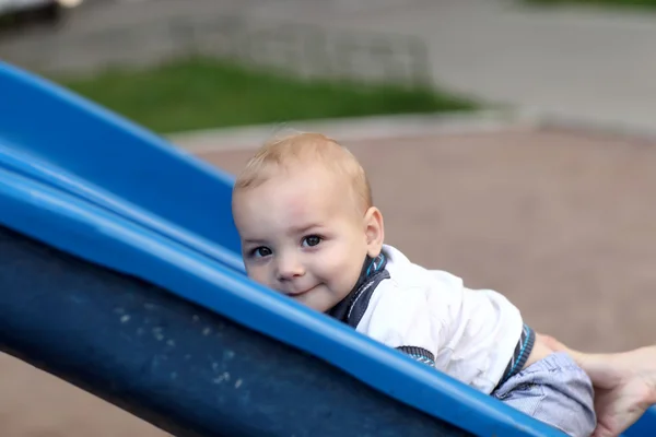Child climbing up slide — Stock Photo, Image