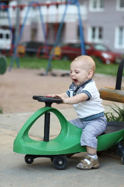 Toddler on toy car — Stock Photo, Image