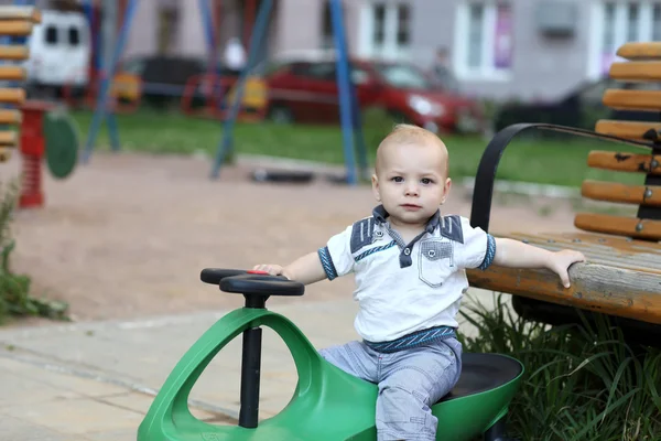 Toddler posing on toy car — Stock Photo, Image