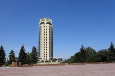 Skyscraper in Almaty on sky background clipart