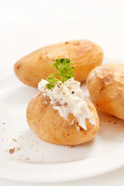 Baked potato filled with soft cheese — Stock Photo, Image
