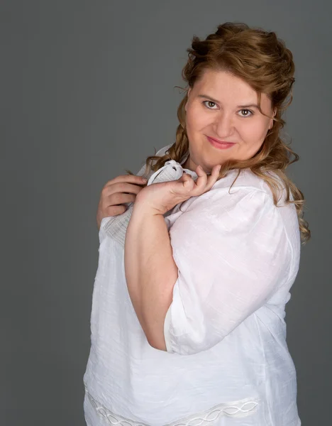 Cheerful fat woman on gray background — Stock Photo, Image