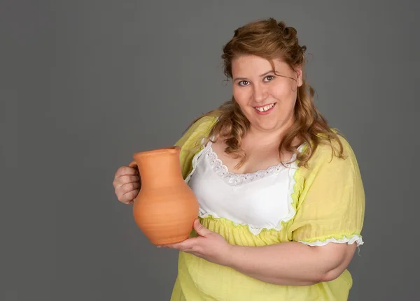 Cute fat woman with a pitcher of milk — Stock Photo, Image